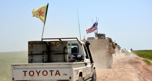 A convoy of US army troops and YPG terrorists patrol near al-Darbasiyah town on the Syrian-Turkish border, April 29.
