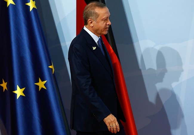 President Recep Tayyip Erdogan walks past the flags of the European Union (L) and Germany as he arrives for the G20 summit in Hamburg, Germany, July 7, 2017. (AFP Photo)