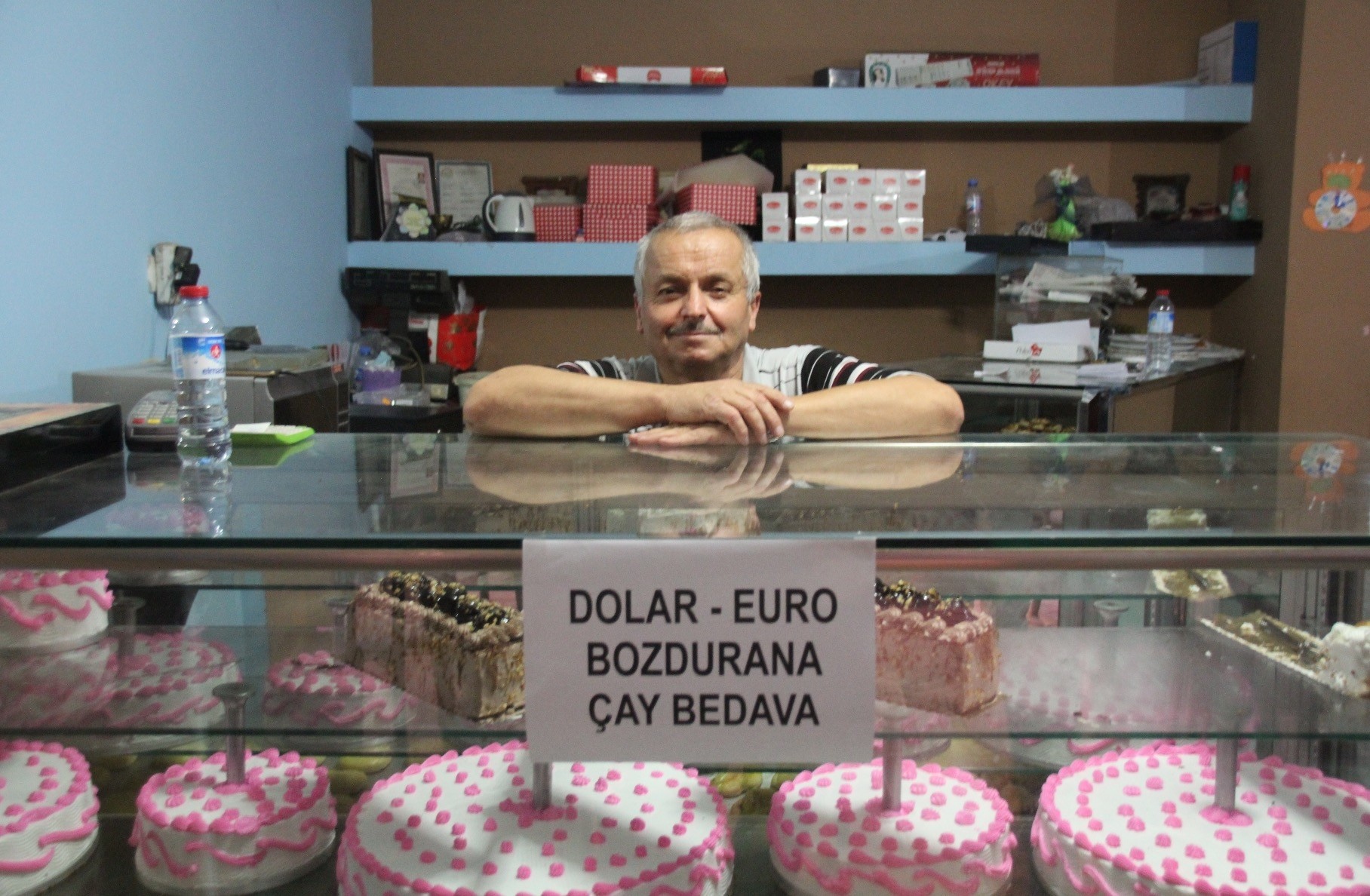 Baker Burhan Uu011furlu from Du00fczce is offering customers free tea if they sell their dollars or euros while Hasan u0130zol from Gaziantep (below) is burning single dollar bills in protest.