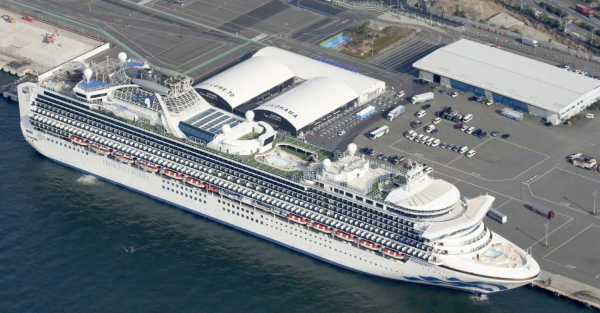 The U.S.-operated Diamond Princess is anchored as emergency vehicles stand by at Yokohama Port, near Tokyo, Wednesday, Feb. 12, 2020. (Kyodo News via AP)