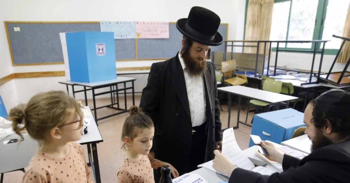 Children accompany an ultra-Orthodox Jewish man to a voting station in the city of Bnei Brak during the Israeli parliamentary election on Sept. 17, 2019 (AFP Photo)