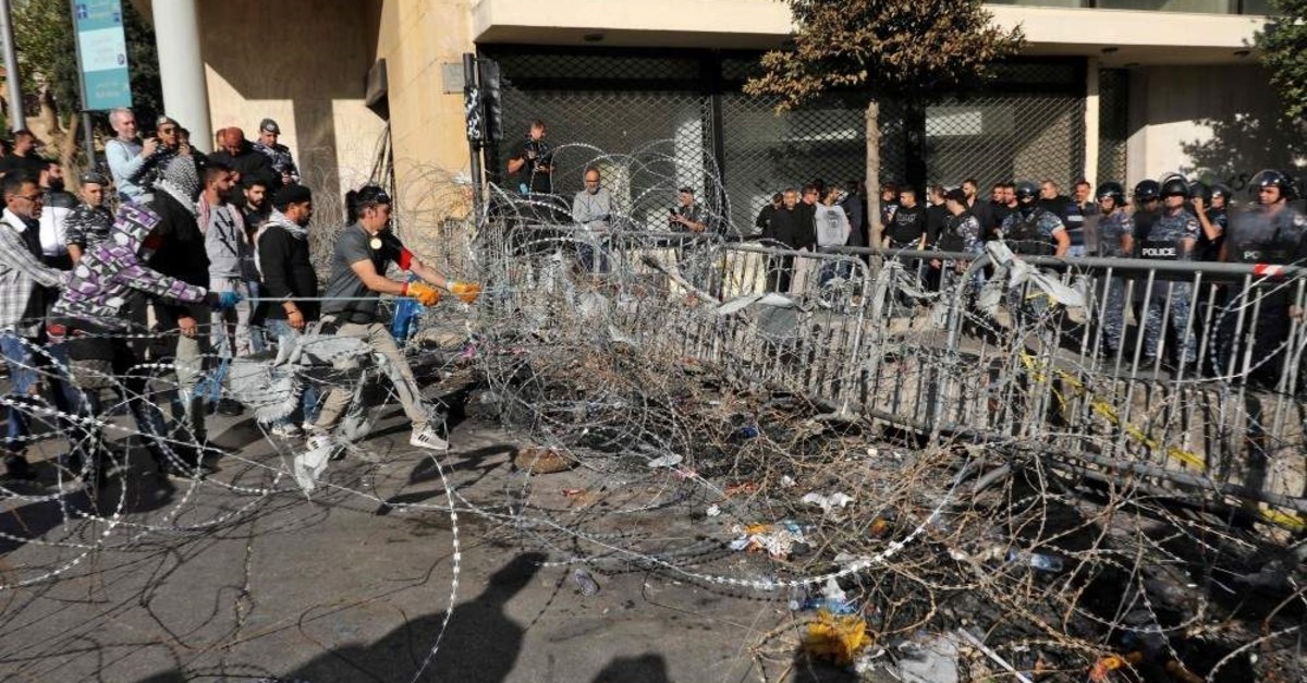 Lebanese protesters use cables to bring down security barriers along a road leading to the parliament headquarters, Beirut, Nov. 19, 2019. (AFP Photo)