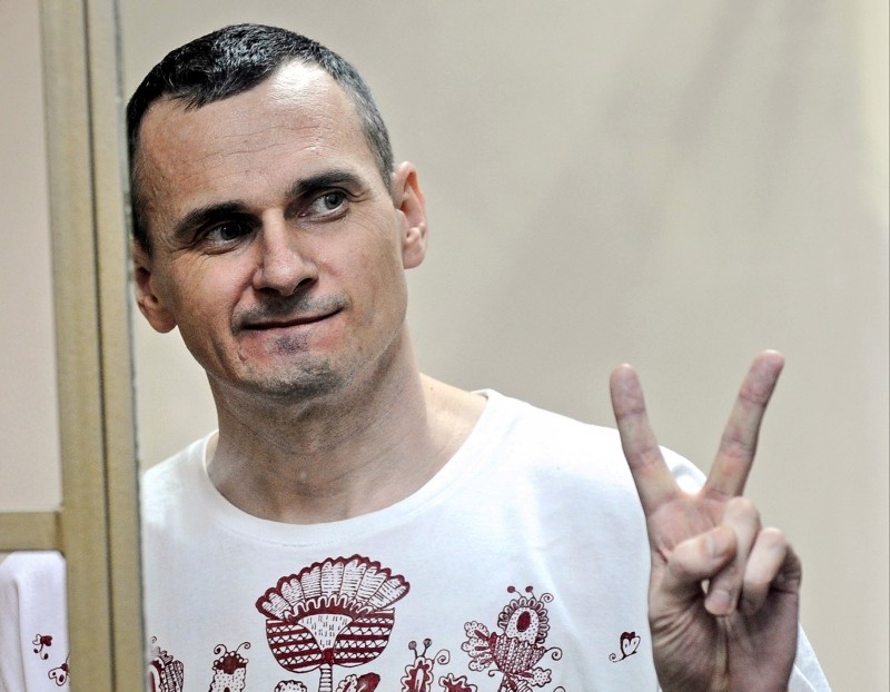 In this Tuesday, Aug. 25, 2015 file photo, Oleg Sentsov gestures as the verdict is delivered, as he stands behind bars at a court in Rostov-on-Don, Russia. (AP Photo)