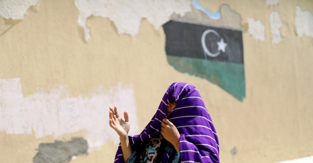 A displaced Libyan woman reacts to clashes between rival groups, Tripoli, April 14, 2019.