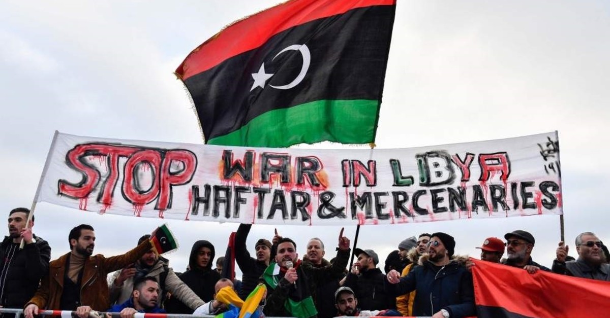 Protesters hold a banner reading ,Stop war in Libya, Haftar and mercenaries, during a protest near the chancellery during the Peace summit on Libya at the Chancellery in Berlin, Jan.19, 2020.(AFP PHOTO)