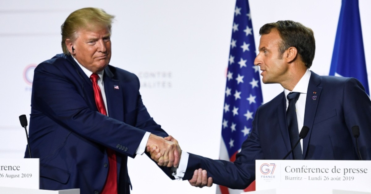  In this file photo taken on August 26, 2019 France's President Emmanuel Macron (R) and US President Donald Trump shake hands as they deliver a joint press conference in Biarritz, south-west France  on the third day of annual G7 Summit (AFP Photo)