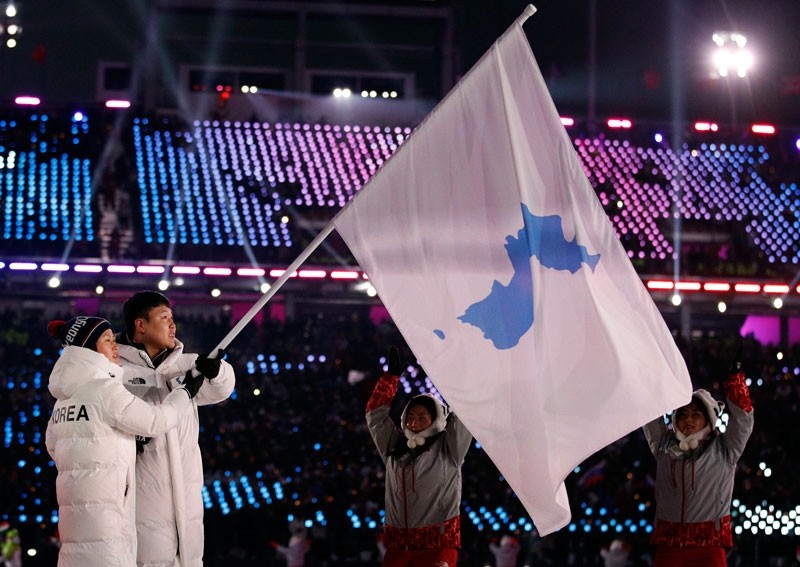 North Korea's Hwang Chung Gum and South Korea's Won Yun-jong carries the flag during the opening ceremony of the 2018 Winter Olympics in Pyeongchang, South Korea, Friday, Feb. 9, 2018. (AP Photo)
