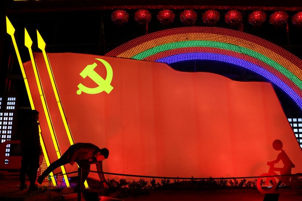 Men check on a light installation in the shape of the party flag of the Communist Party of China set up to celebrate the upcoming Chinese Lunar New Year, in Jining, Shandong province, China, Jan. 29, 2019.