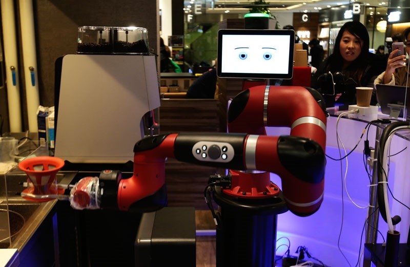 Robot barista named ,Sawyer, makes a coffee at Henn-na Cafe, Japanese meaning ,Strange Cafe,in Tokyo, Friday, Feb. 2, 2018 (AP Photo)