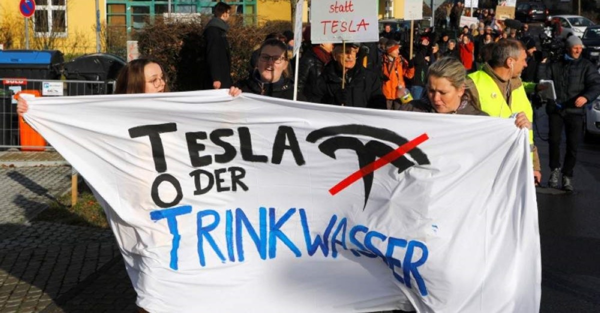 Demonstrators hold anti-Tesla posters during a protest against plans by U.S. electric vehicle pioneer Tesla to build its first European factory and design center in Gruenheide near Berlin, Germany January 18, 2020. (Reuters Photo)