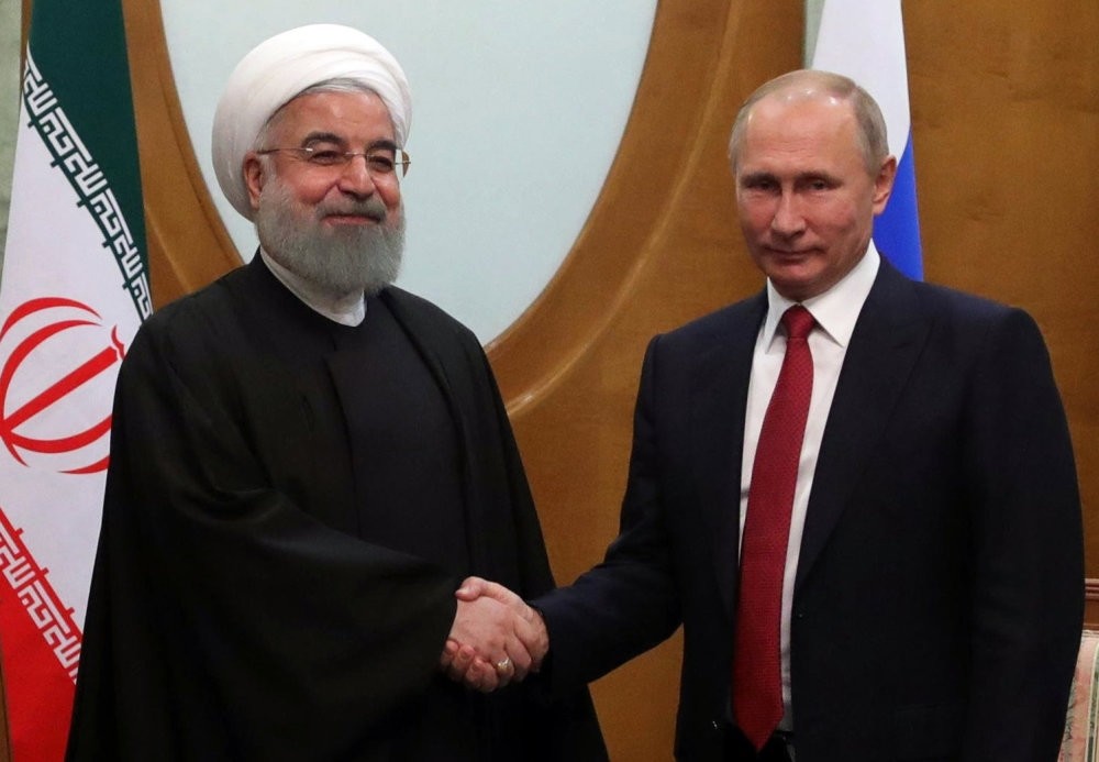 Iranian President Hassan Rouhani (L) shakes hands with Russian President Vladimir Putin (R) during a meeting in the Black sea resort city of Sochi, Russia, Nov. 22, 2017