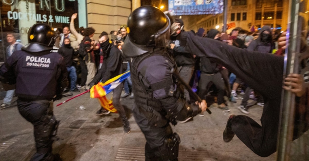 A Catalan pro-independence protester kicks a Catalan Police officer during clashes following a demonstration in Barcelona, Spain, Saturday, Oct. 26, 2019. (AP Photo)