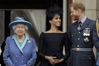 Britain's Queen Elizabeth II, Meghan the Duchess of Sussex and Prince Harry watch a flypast of Royal Air Force aircraft over Buckingham Palace, London, July 10, 2018. (AP Photo)