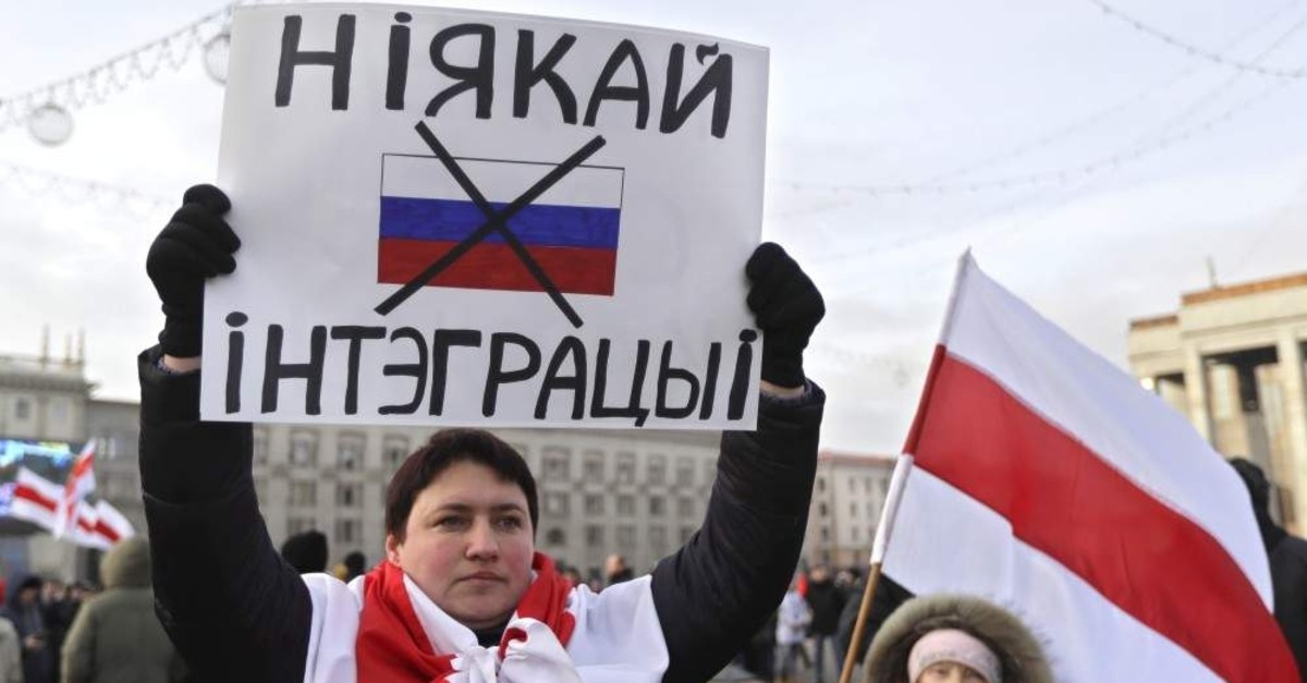 A protester holds a banner reading 'No to integration!' during a rally in downtown Minsk, Belarus, Saturday, Dec. 7, 2019. (AP Photo)