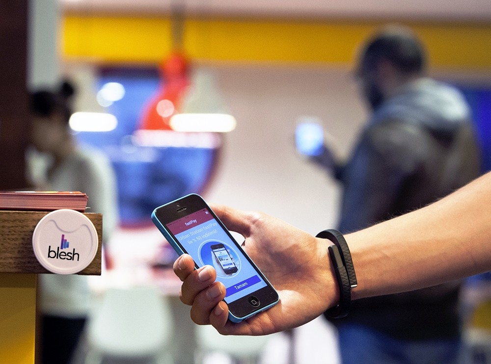 Man showing the Blesh app on his smartphone. Blesh initiated their Beacon tech more than two years ago. the number of Beacon users increased from 20,000 to 90,000 in the last two years.