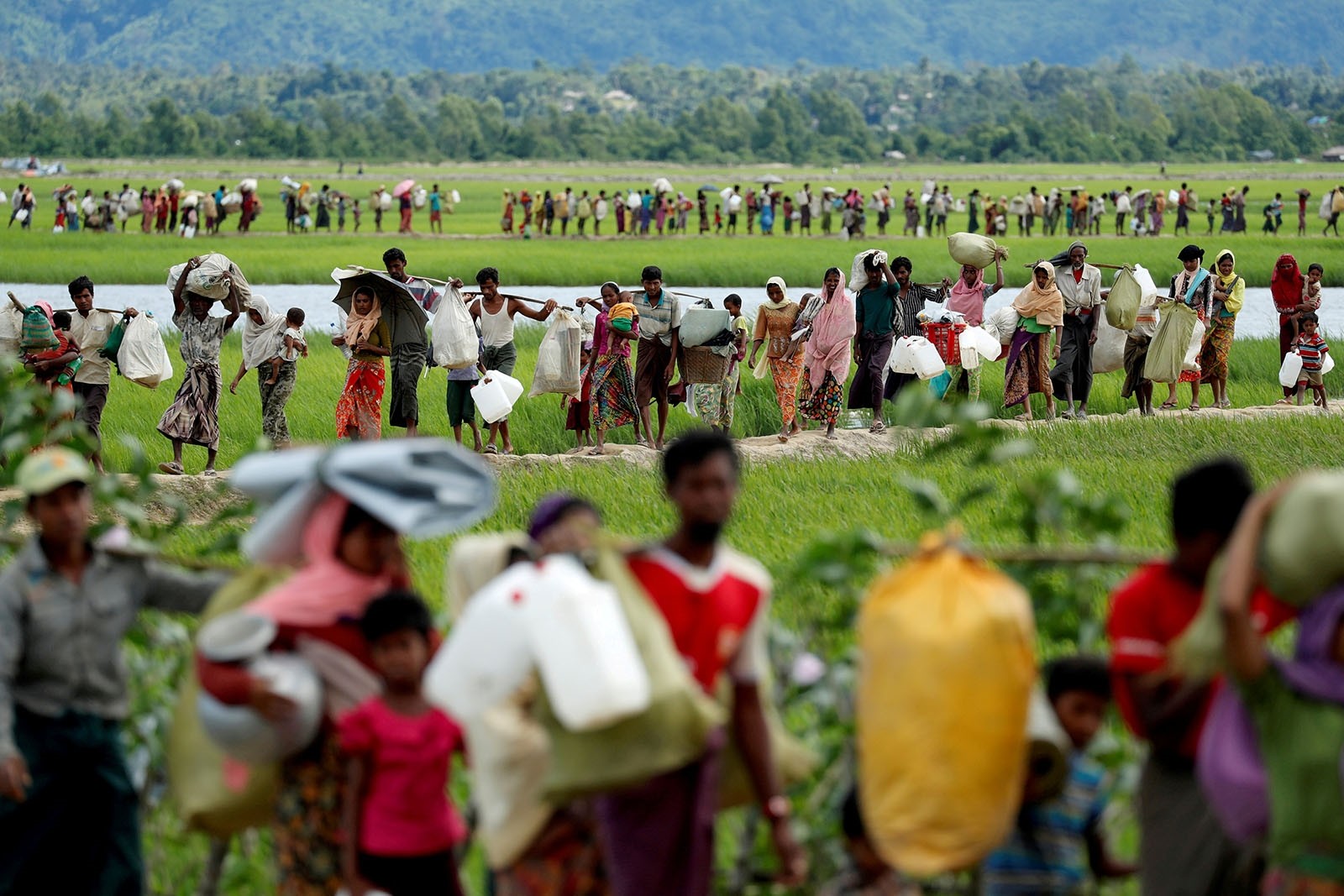 Rohingya refugees, who crossed the border from Myanmar two days before, walk after they received permission from the Bangladeshi army to continue on to the refugee camps, in Palang Khali, near Cox's Bazar, Bangladesh October 19, 2017.