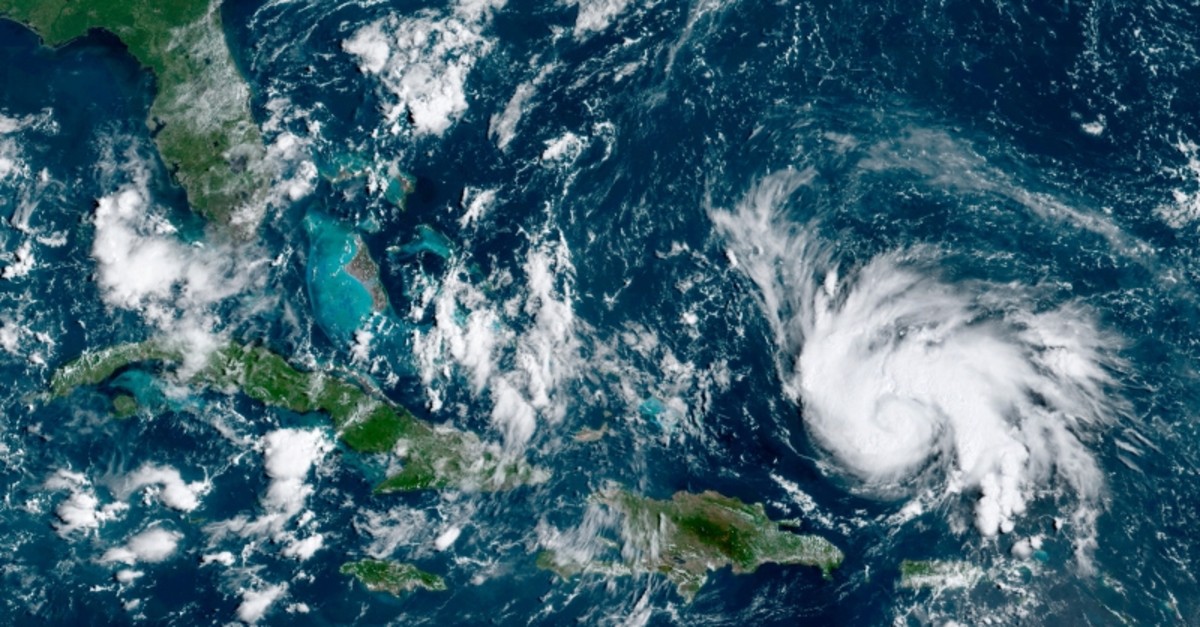 This GOES-16 satellite image taken Thursday, Aug. 29, 2019, at 14:20 UTC and provided by National Oceanic and Atmospheric Administration (NOAA), shows Hurricane Dorian, right, moving over open waters of the Atlantic Ocean. (AP Photo)