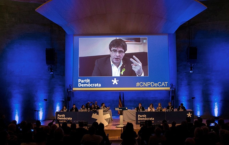 Former Catalan regional president Carles Puigdemont is seen on a screen as he delivers a speech during an act of pro-independence left-wing party Esquerra Repulicana de Catalunya (ERC) held in Barcelona, Catalonia, Spain, 13 January 2018. (EPA Photo)