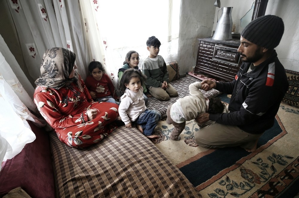 Khaled and Nevroz Ahmer, a Syrian family hailing from eastern Ghouta, play with their children in their home in the central city of Konya on Jan. 18, 2019.