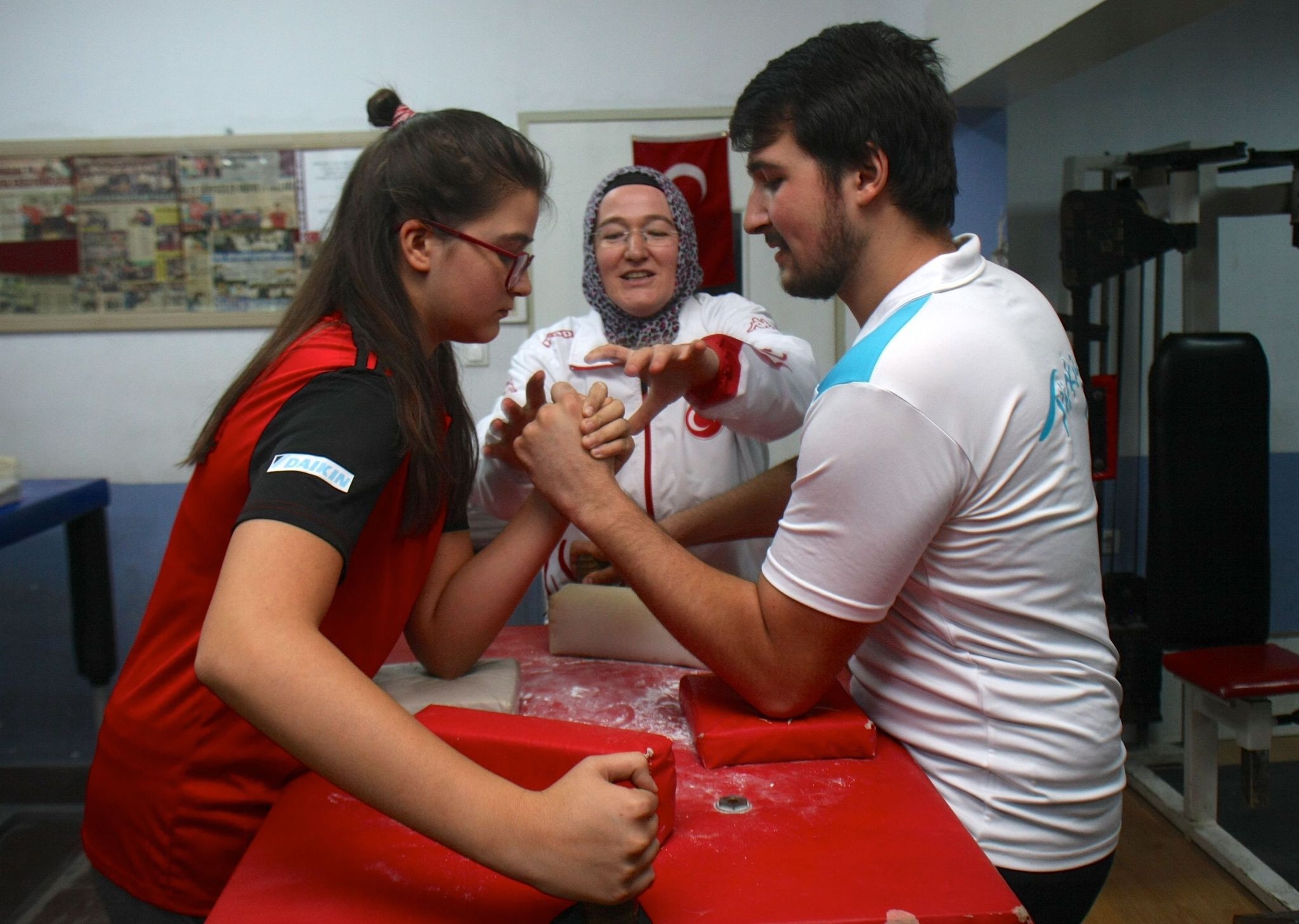 The u00dcstu00fcnkaya family in action preparing for the next arm wrestling medal.