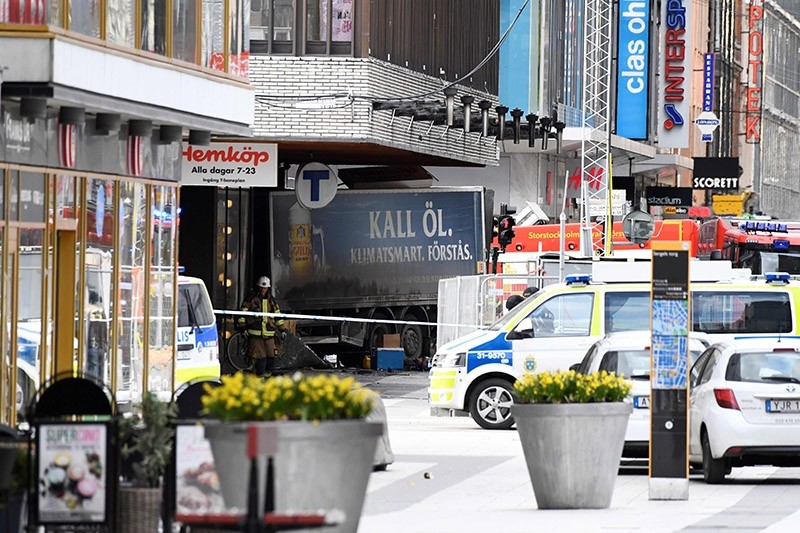 This file photo taken on April 7, 2017 shows emergency services members working at the scene where a truck crashed into the Ahlens department store at Drottninggatan in central Stockholm, April 7, 2017. (AFP Photo)
