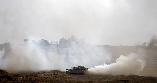 Israeli tanks train at the Golan Heights area, on the Israeli-Syrian border (EPA Photo)