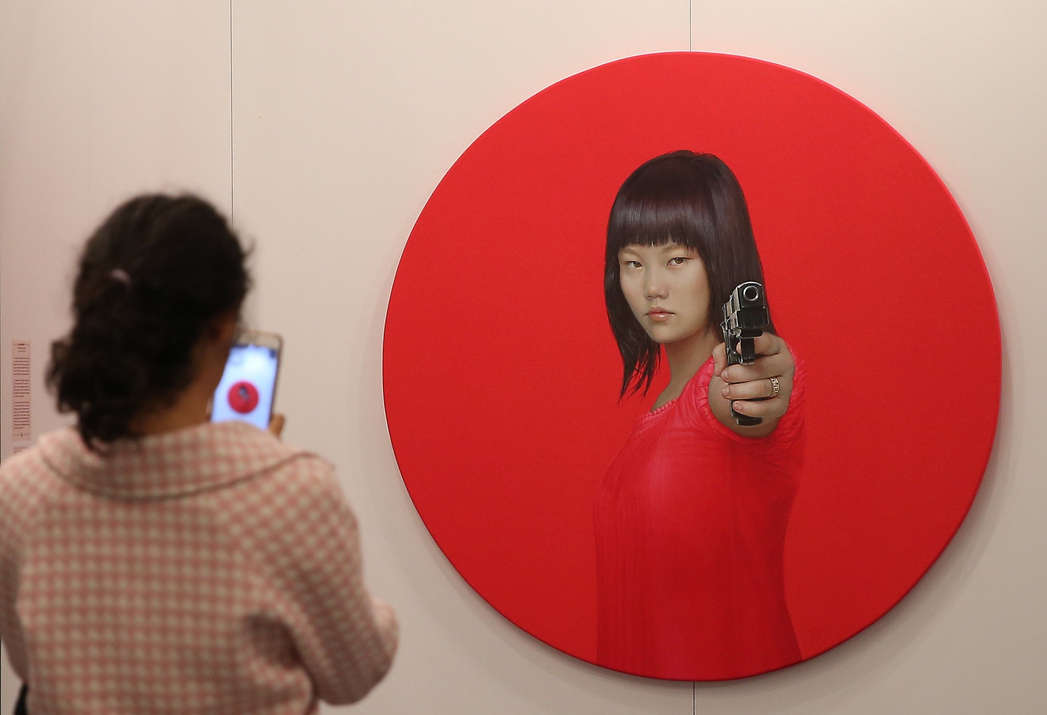 An art enthusiast takes a photo of one of the artworks being exhibited at the 13th Contemporary Art Istanbul.