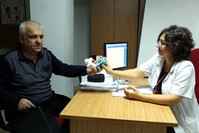 Mehmet Au015fan, a smoker for 50 years, tries a smokerlyzer in the company of Dr. Lu00fctfiye u015eahin, in u0130zmir, Feb. 8, 2019. State-run clinics offer free treatment for smokers looking to quit.