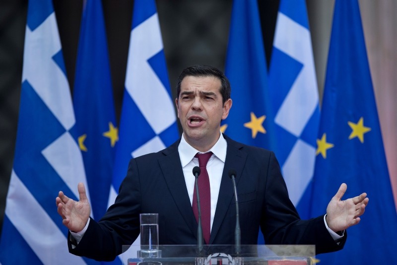 Greek Prime Minister Alexis Tsipras speaks to lawmakers from his left-led governing coalition in Athens, wearing a tie for the first time in more than three years, on Friday, June 22, 2018. (AP Photo)