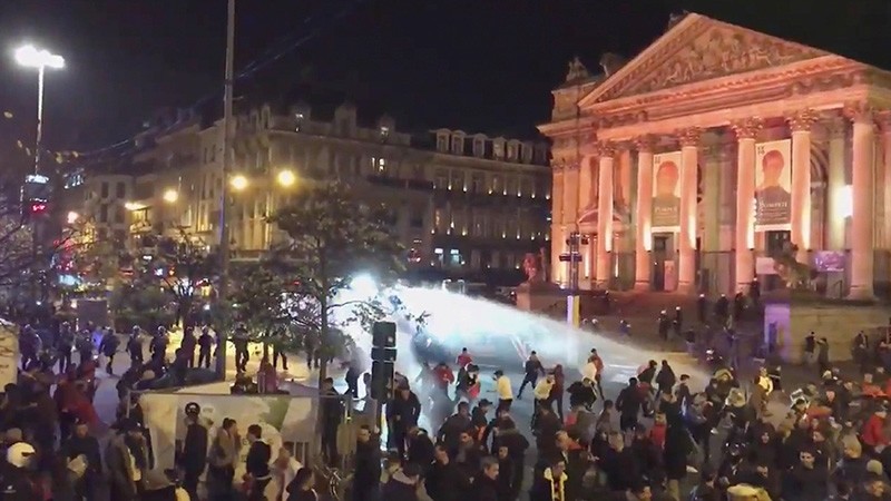 Video grab shows riot police spraying water into the crowd using a water cannon in Brussels, Belgium November 11, 2017 in this image taken from video obtained from social media. (Reuters Photo)