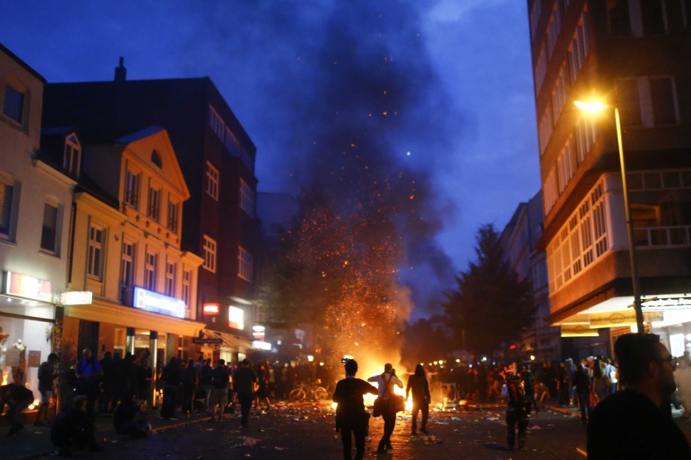 Barricades burn as protesters clash with riot police during the protests at the G20 summit in Hamburg, Germany, July 7, 2017. 