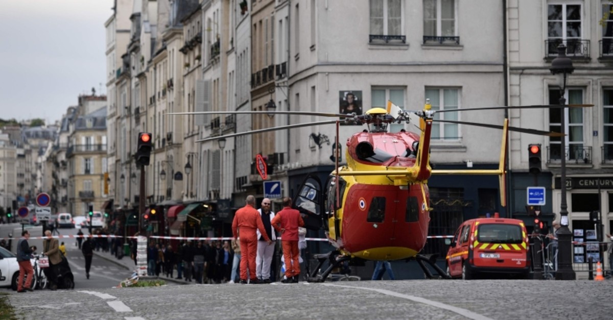 Emergency personnel stand near an air ambulance helicopter on the Pont Marie near Paris prefecture de police (police headquarters) after three persons have been hurt in a knife attack on Oct. 3, 2019. (AFP Photo)