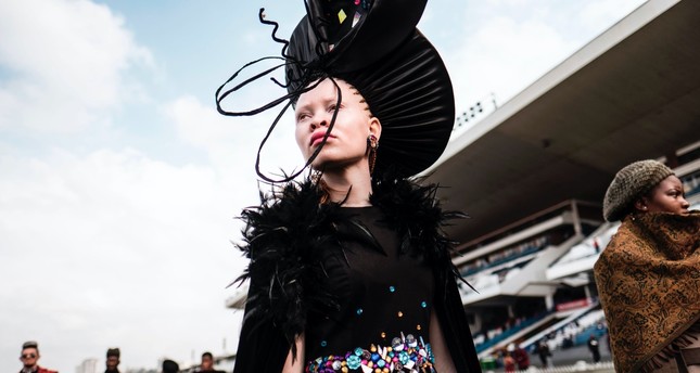 An Albino model presents a creation by a local designer during a fashion show at the 2017 Durban July horse race.