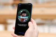 A customer sets his new iPhone's Face ID after purchase. Although the technology has been around for a while, with the new iPhone, it will be more common.