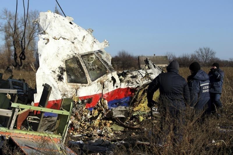 Local workers transport a piece of wreckage from Malaysia Airlines flight MH17 at the site of the plane crash near the village of Hrabove (Grabovo) in Donetsk region, eastern Ukraine November 20, 2014. (Reuters Photo)