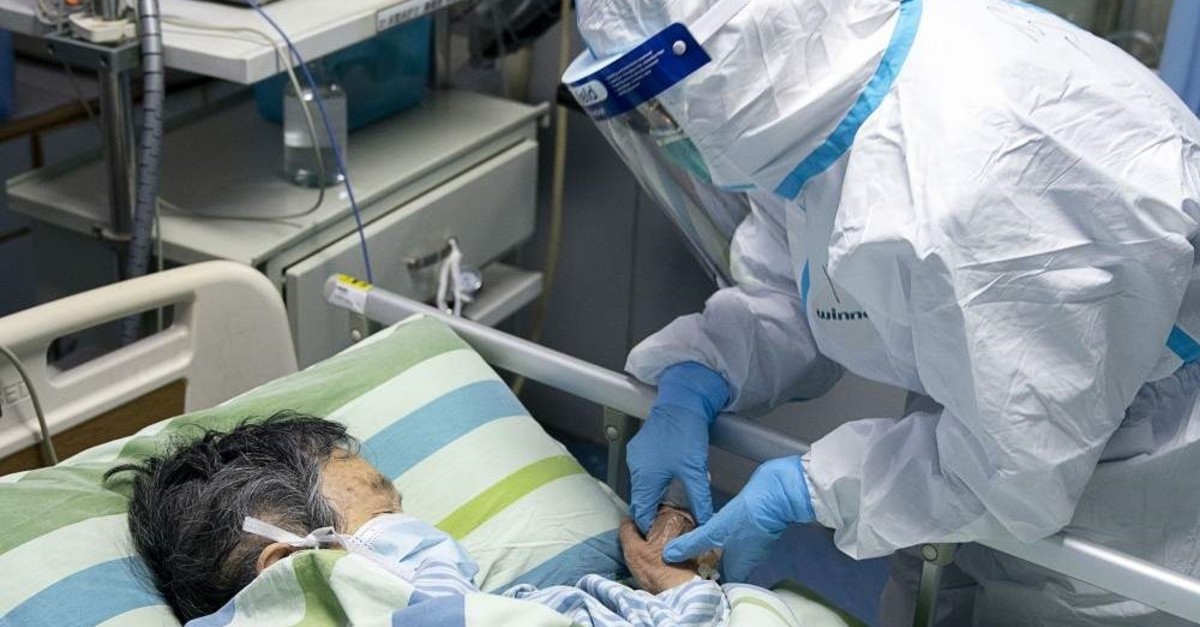 In this Friday, Jan. 24, 2020, photo released by China's Xinhua News Agency, a medical worker attends to a patient in the intensive care unit at Zhongnan Hospital of Wuhan University in Wuhan in China's Hubei Province. (Xiong Qi/Xinhua via AP)