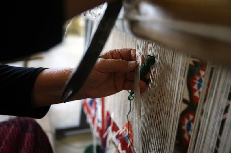 A woman weaves a traditional rug in Bayat, Afyonkarahisar, Turkey. (AA Photo)
