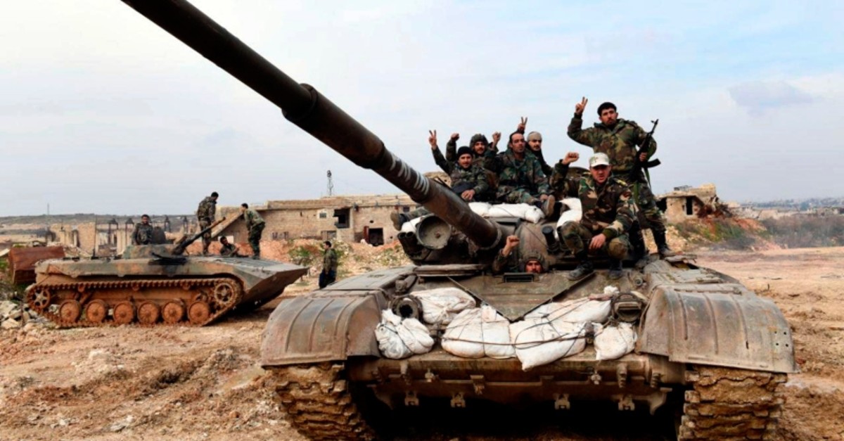 This Monday, Jan. 27, 2020, photo, released by the Syrian official news agency SANA, Syrian regime soldiers flash the victory sign as they stand on their tank in western rural Aleppo, Syria. (SANA via AP)