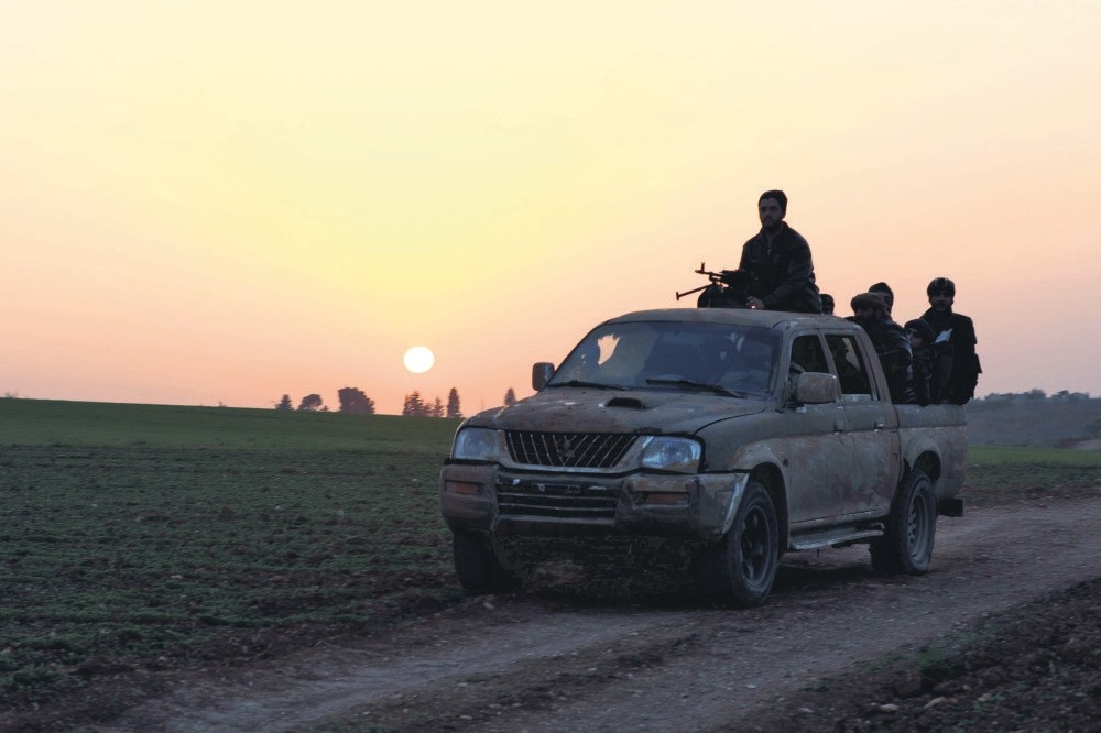 Opposition members head towards the village of Al-Khuwayn during battles with regime forces in Idlib, Jan. 13.