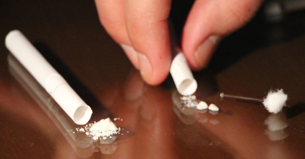 Police inspect cocaine hidden in cigarettes after the drug was seized from a suspect in Istanbul's Fatih