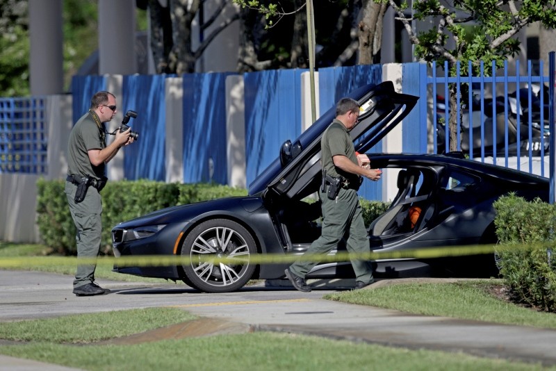 Investigators surround a vehicle after rapper XXXTentacion was shot in Deerfield Beach, Fla. (AP Photo)