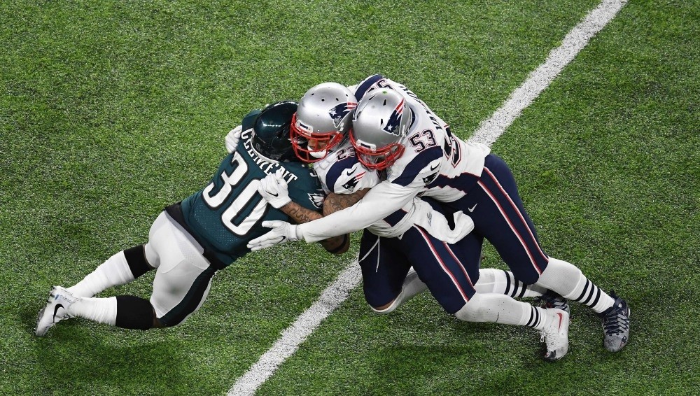 Corey Clement (30) of the Eagles collides with Patrick Chung (23) and Kyle Van Noy (53) of the Patriots during Super Bowl LII between the New England Patriots and the Philadelphia Eagles at U.S. Bank Stadium in Minneapolis.