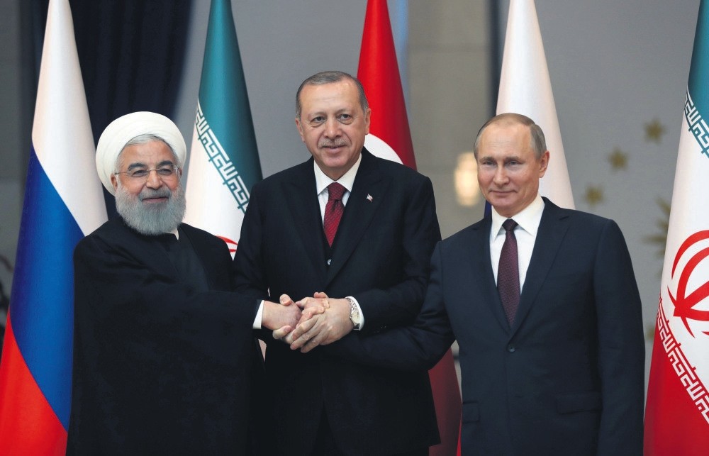 Presidents Rouhani of Iran (L), Erdou011fan (C) and Putin of Russia pose before meeting on the Syrian crisis, Ankara, April 4. 