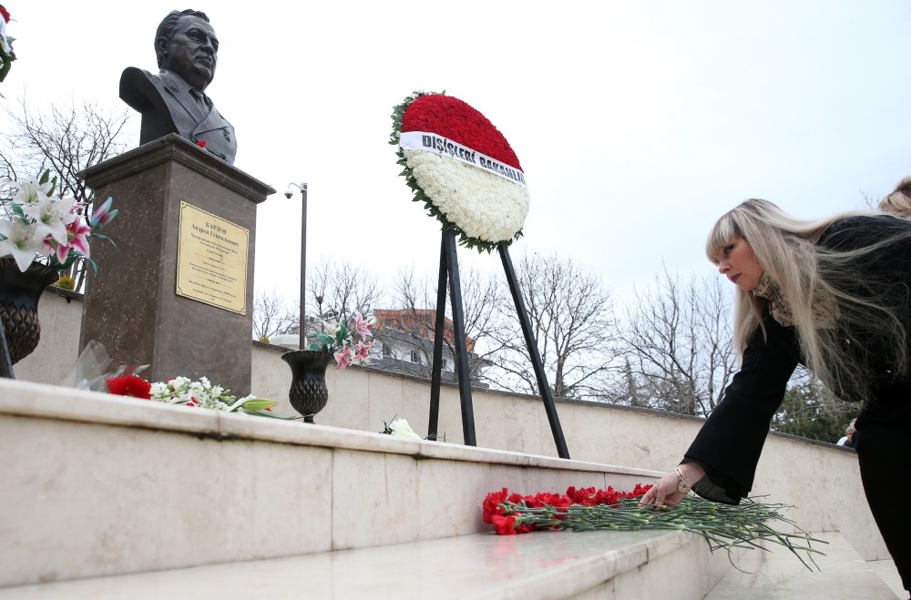 People lay flowers in front of a monument dedicated to Karlov at the Russian embassy in Ankara yesterday.
