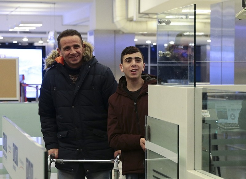 Fawzi al-Juneidi, right, and his father passing through passport control post at Atatu00fcrk International Airport, Istanbul, Turkey, Jan. 16, 2017. (AA Photo)