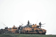 Turkish soldiers stand on an armored vehicle in a village near the Turkish-Syrian border, Hatay, Feb. 25. 
