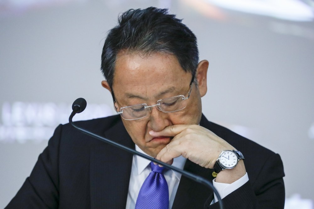 Akio Toyoda, President of Toyota Motor Corp., looks at his files during a press conference announcing the company's financial results.