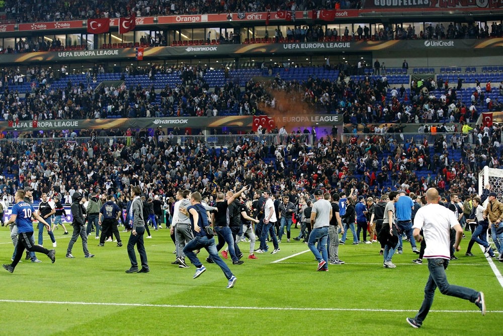 Supporters invade the pitch before the UEFA Europa League quarter final, first leg soccer match between Olympique Lyon and Besiktas Istanbul. (EPA Photo)