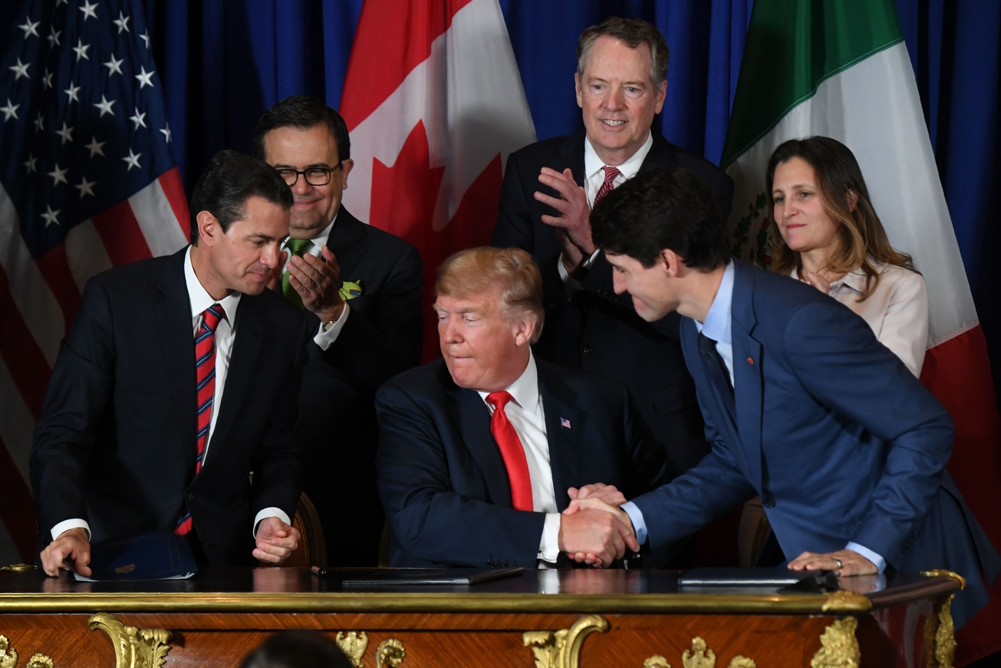 Left to right, Mexican President Enrique Pena Nieto, U.S. President Donald Trump and Canadian Prime Minister Justin Trudeau sign a new free trade agreement in Buenos Aires, on the sidelines of the G20 summit, Nov. 28.