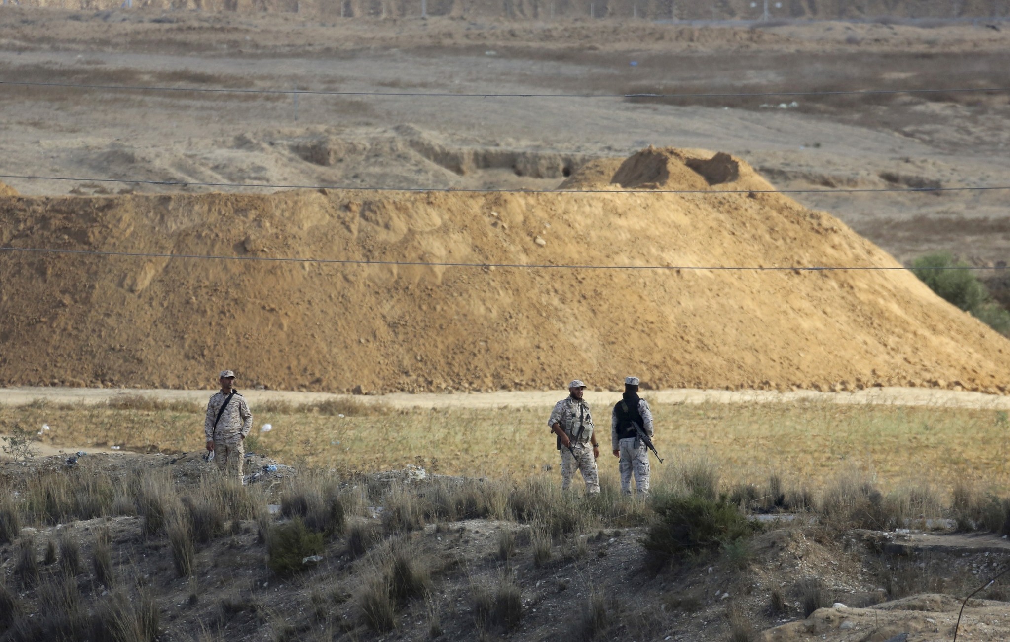 Hamas security forces petrol at the site while Palestinian bulldozers search the destroyed tunnel for the missing of five soldiers near the Israeli border east of Khan Younis, Gaza Strip, Friday, Nov. 3, 2017.  (AP Photo)